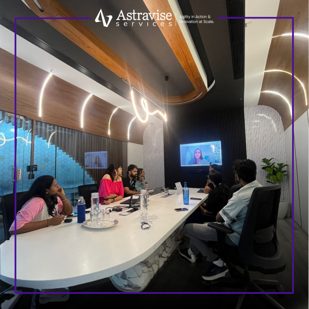 Team attending Women’s Day leadership webinar in meeting room discussing empowerment and inclusion